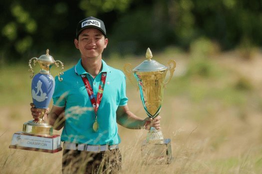 Junior golfer with two championship trophies