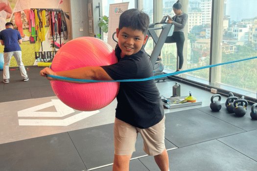 Junior athlete training with stability ball and band