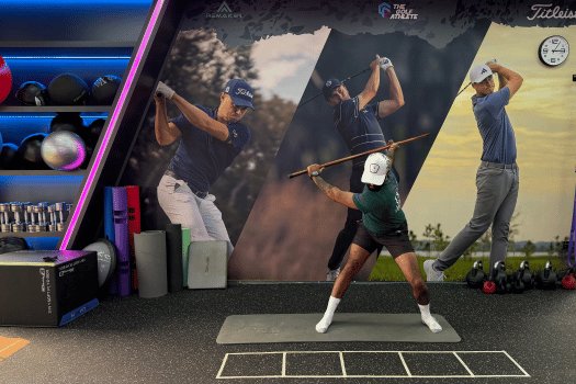 The Golf Athlete Hanoi studio — swing screens and rack